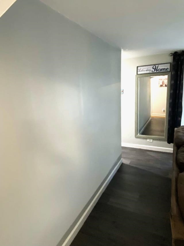 hallway with dark wood-type flooring