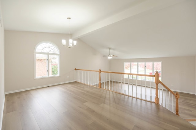 unfurnished room with light hardwood / wood-style flooring, lofted ceiling with beams, and ceiling fan with notable chandelier