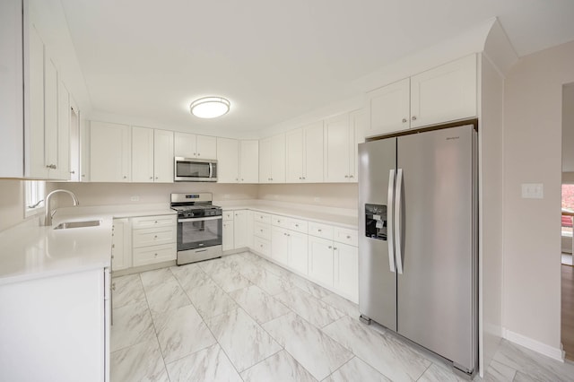 kitchen with white cabinets, stainless steel appliances, and sink