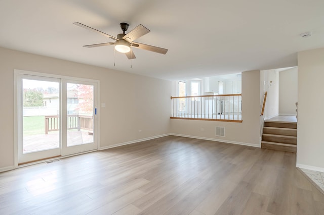 spare room featuring light hardwood / wood-style floors, plenty of natural light, and ceiling fan