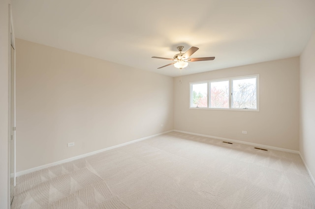 spare room with light carpet and ceiling fan