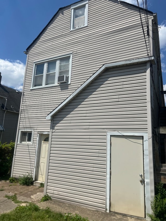 rear view of property featuring cooling unit