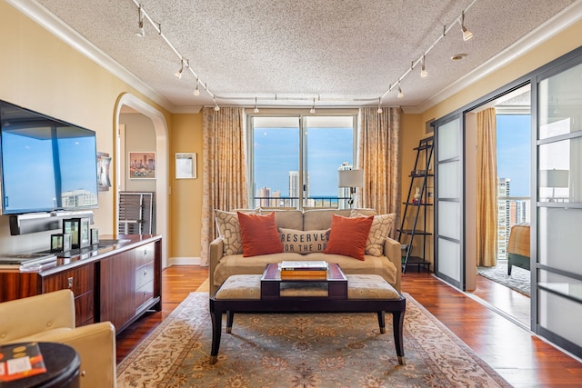 sitting room featuring crown molding, a textured ceiling, track lighting, and hardwood / wood-style floors