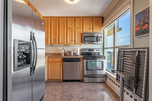 kitchen featuring light stone countertops, appliances with stainless steel finishes, and a textured ceiling