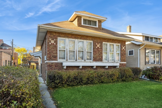 rear view of house featuring a yard