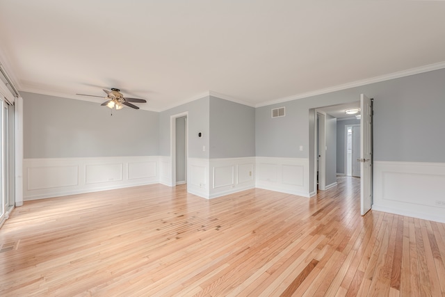 spare room featuring ceiling fan, ornamental molding, and light hardwood / wood-style flooring