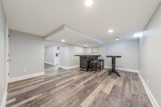 exercise room with dark hardwood / wood-style floors and bar area