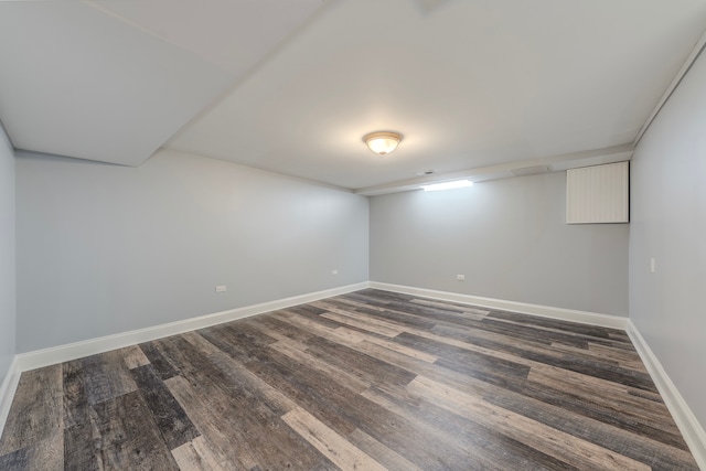 spare room with dark wood-type flooring