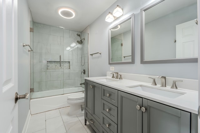 full bathroom featuring toilet, combined bath / shower with glass door, vanity, and tile patterned flooring