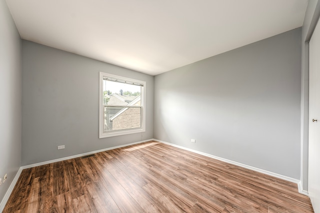 empty room with hardwood / wood-style flooring