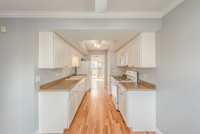 kitchen featuring white cabinetry, light hardwood / wood-style flooring, ornamental molding, sink, and white appliances