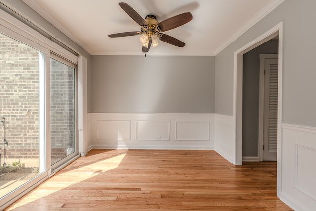 spare room with ornamental molding, light wood-type flooring, and ceiling fan