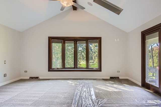 empty room featuring ceiling fan, vaulted ceiling, and carpet floors