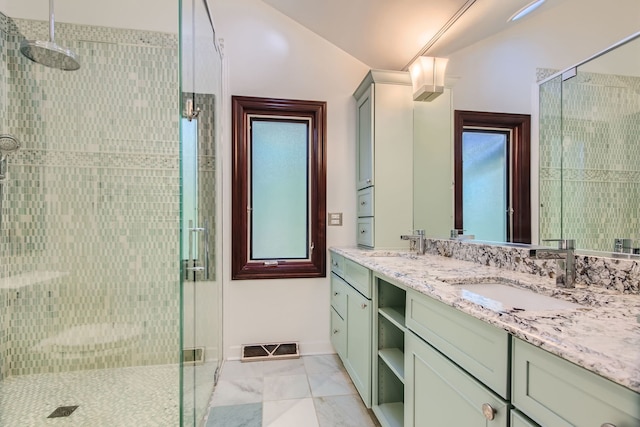 bathroom featuring vanity, walk in shower, and lofted ceiling