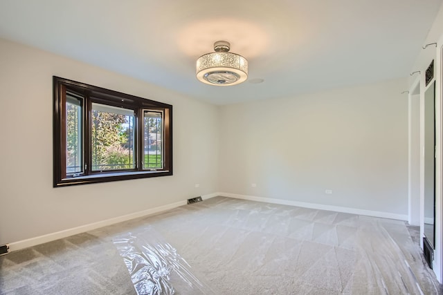 unfurnished room featuring light carpet