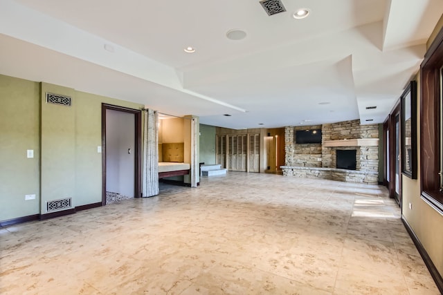 unfurnished living room with a stone fireplace