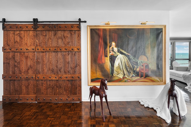 interior details with parquet flooring and a barn door