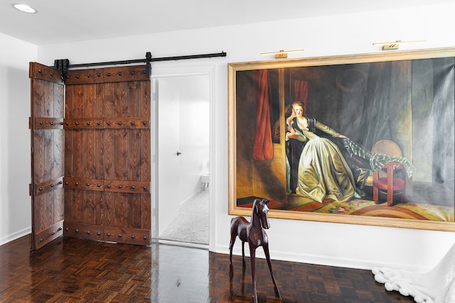 interior space featuring parquet flooring and a barn door