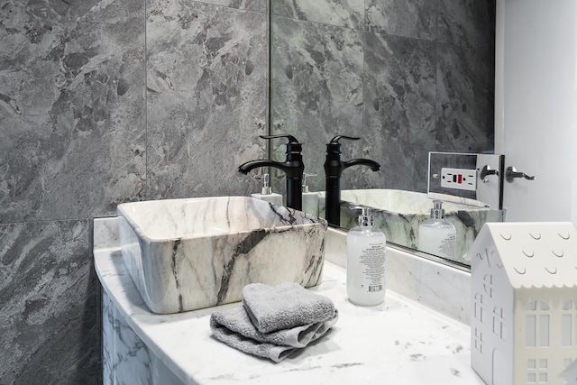 bathroom with tile walls and sink