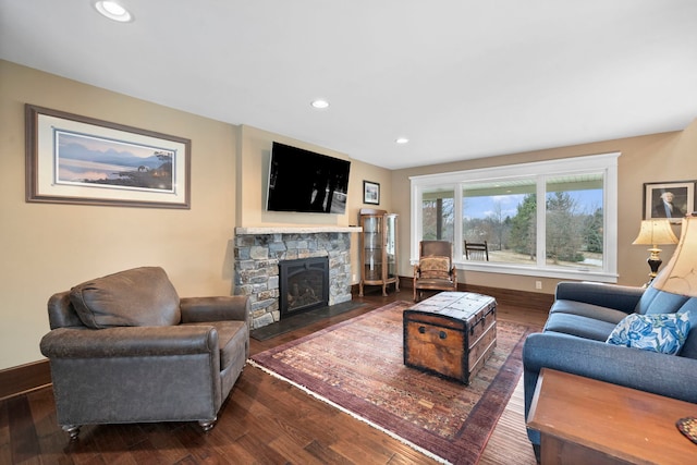 living room featuring dark hardwood / wood-style floors and a fireplace