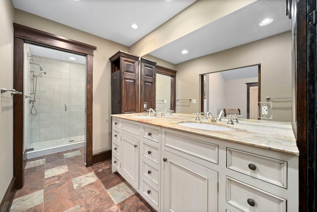 bathroom featuring walk in shower and vanity