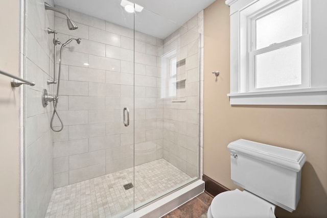 bathroom with toilet and walk in shower