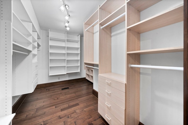 walk in closet featuring dark wood-type flooring