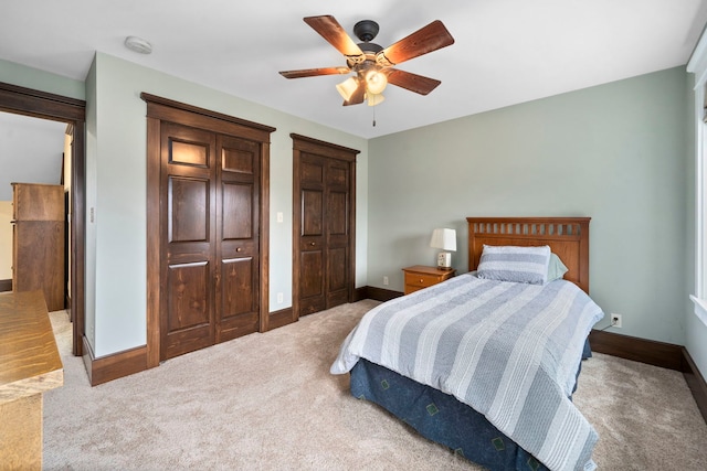 bedroom with ceiling fan and light carpet