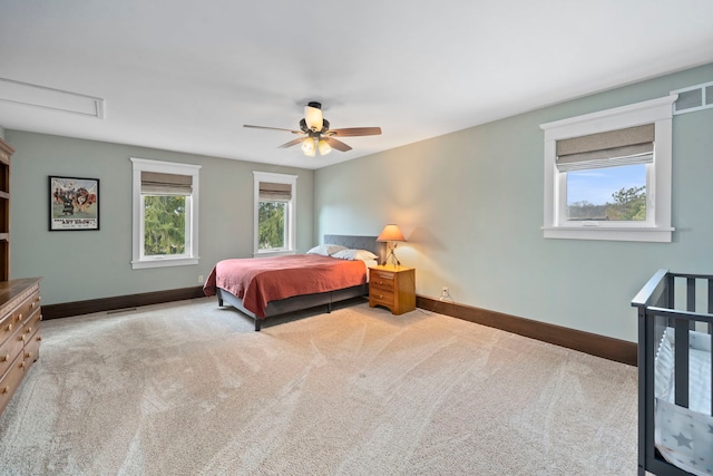 bedroom featuring light colored carpet and ceiling fan