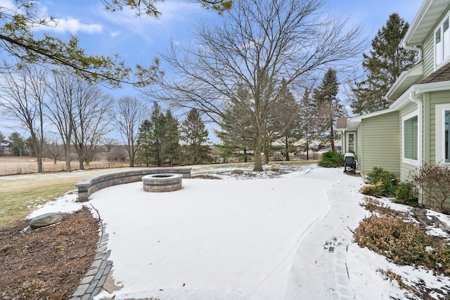 snowy yard with a fire pit