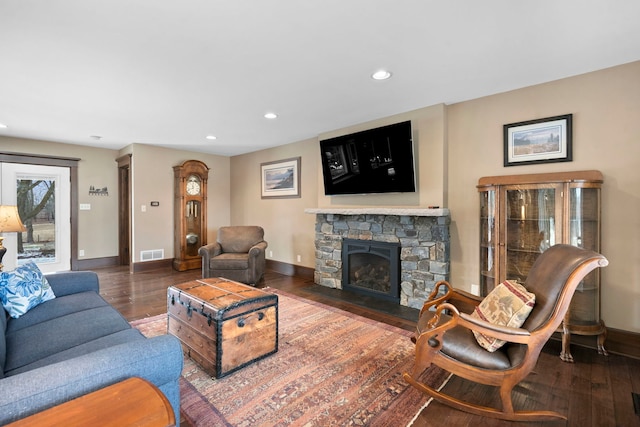 living room with a fireplace and dark hardwood / wood-style flooring