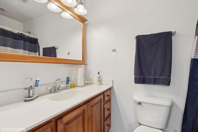 bathroom featuring toilet and vanity