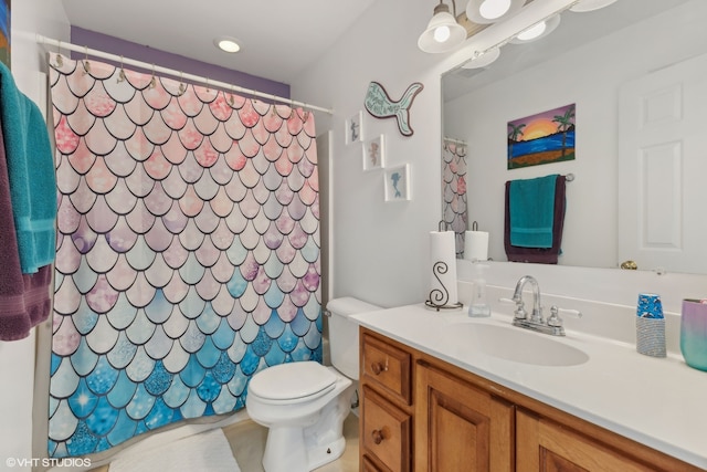 bathroom featuring vanity, toilet, and a shower with curtain