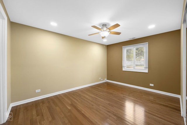 spare room with hardwood / wood-style floors and ceiling fan