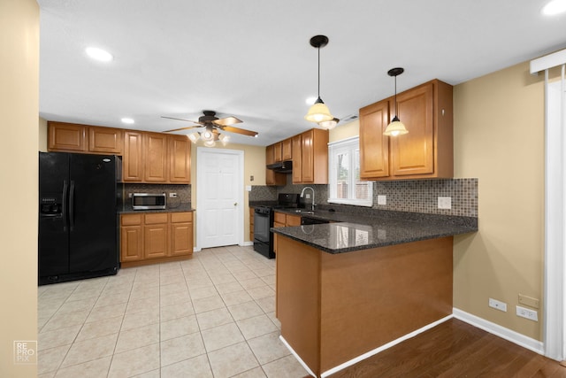 kitchen featuring black appliances, hanging light fixtures, decorative backsplash, kitchen peninsula, and ceiling fan