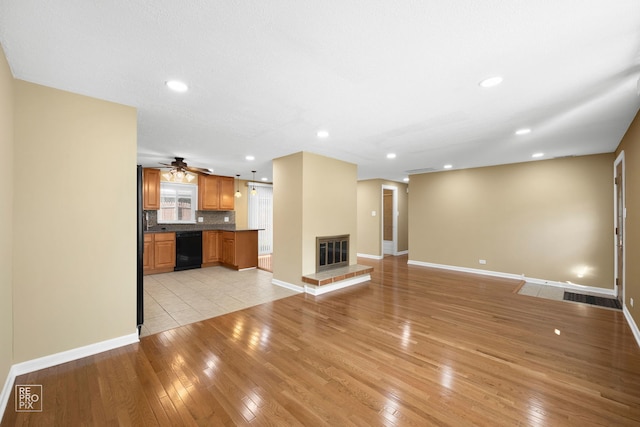 unfurnished living room featuring light hardwood / wood-style floors and ceiling fan