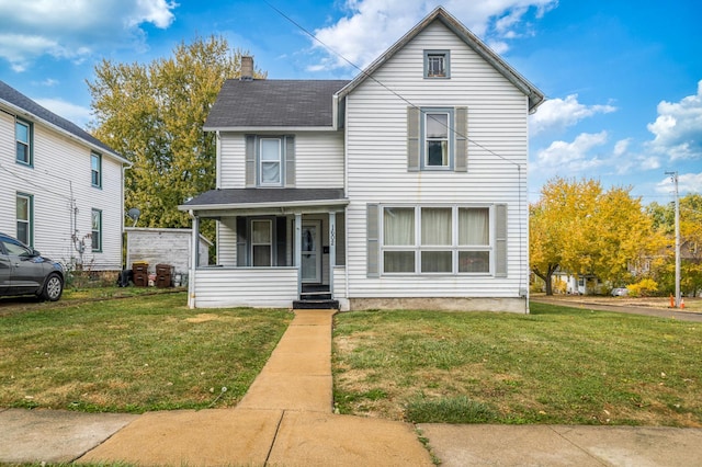 view of front property with covered porch and a front lawn