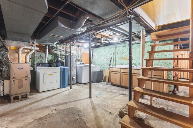 basement featuring washer and dryer and water heater