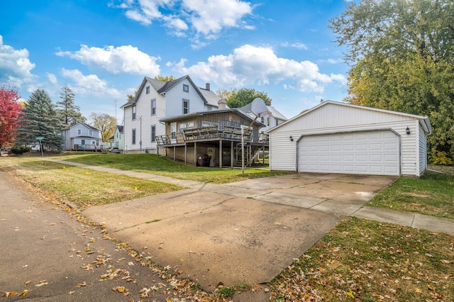 view of front of property with a wooden deck, a front lawn, and a garage