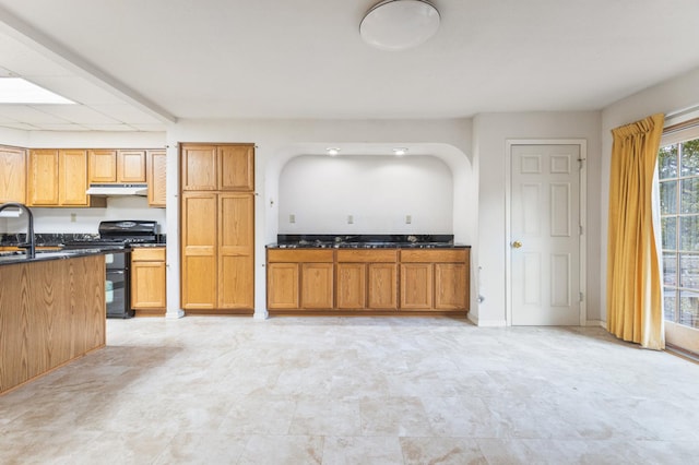 kitchen featuring sink and black range