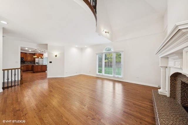 living room featuring wood-type flooring and a towering ceiling