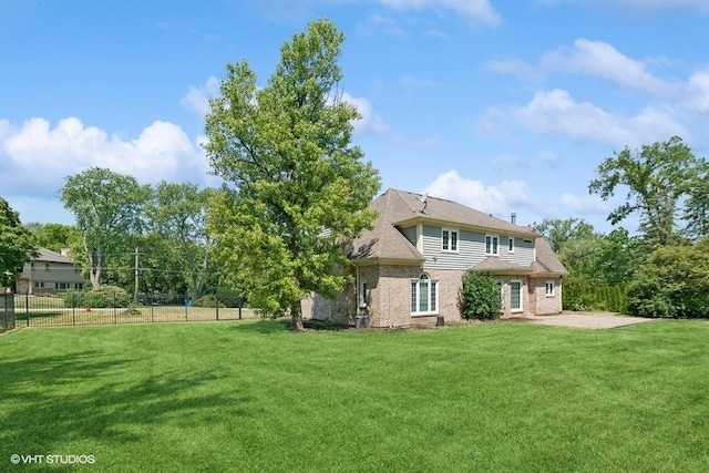 rear view of property featuring a lawn