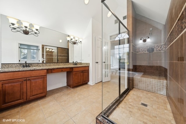 bathroom featuring vanity, a notable chandelier, walk in shower, and tile patterned flooring