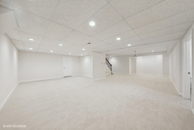 basement with a drop ceiling and carpet flooring