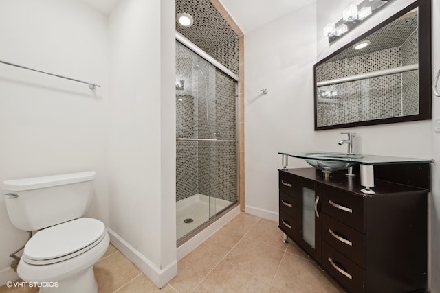 bathroom with vanity, tile patterned floors, toilet, and walk in shower