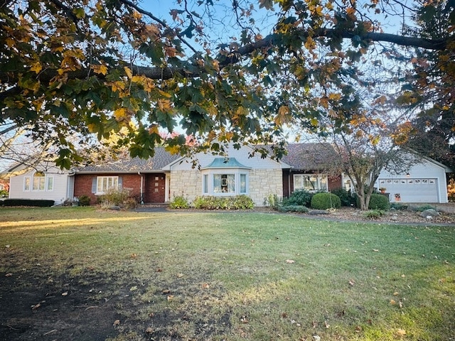 ranch-style home featuring a front yard and a garage