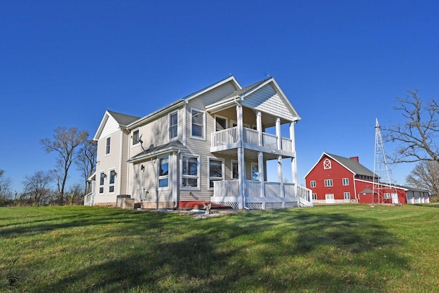 view of front of property featuring a front yard and a balcony