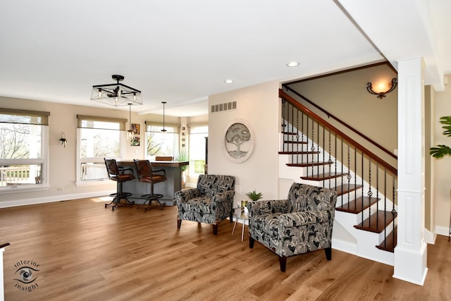 sitting room with hardwood / wood-style flooring and plenty of natural light