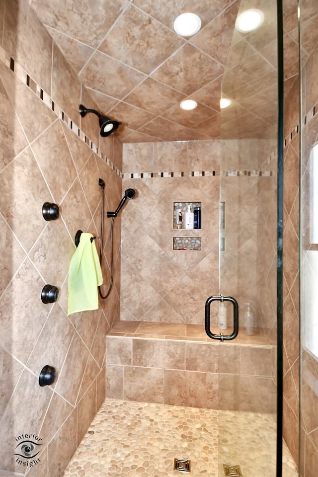 bathroom featuring a shower with door