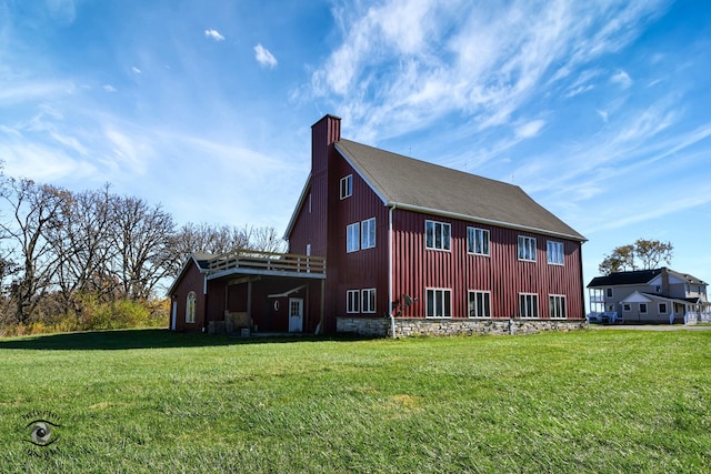 view of side of home featuring a yard and a deck